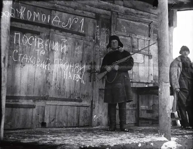 A worker guarding stores of grain collected from the villages during the Holodomor in Ukraine in 1932 1933 via HREC Education